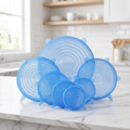 LeakGuard blue silicone stretch lids - all 6 sizes fanned out with smiley face