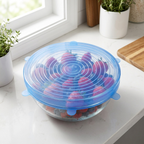 LeakGuard blue stretch lid sealing a glass bowl of fresh berries
