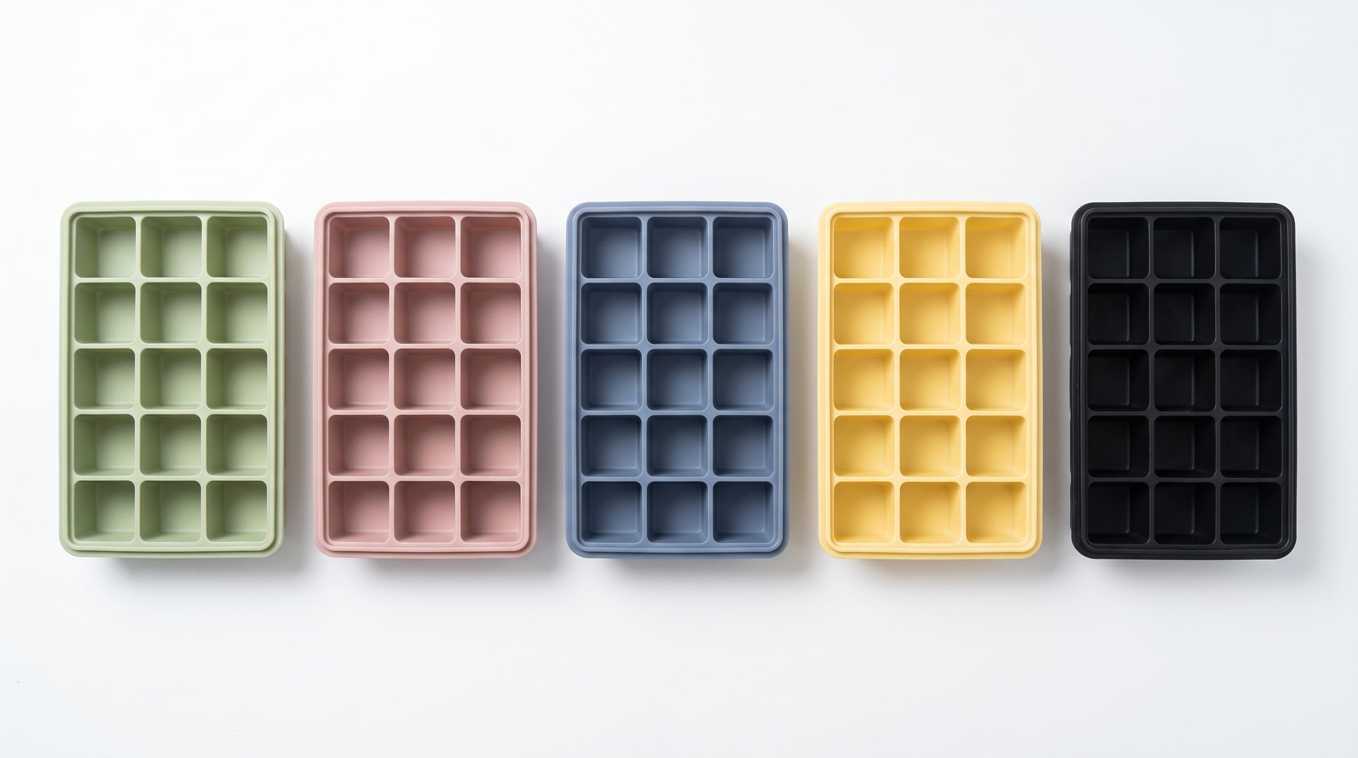 Five LeakGuard silicone ice cube trays in green, pink, blue, yellow and black